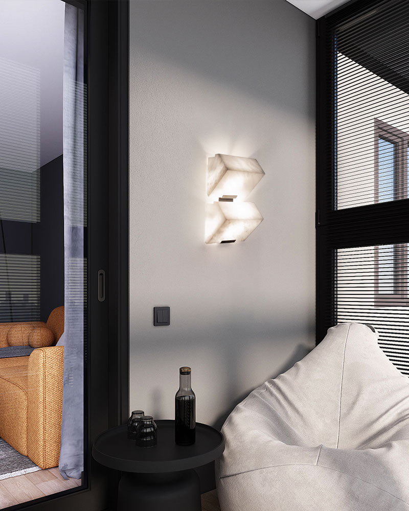 LED alabaster wall sconce with sloping blocks illuminating modern living room decor
