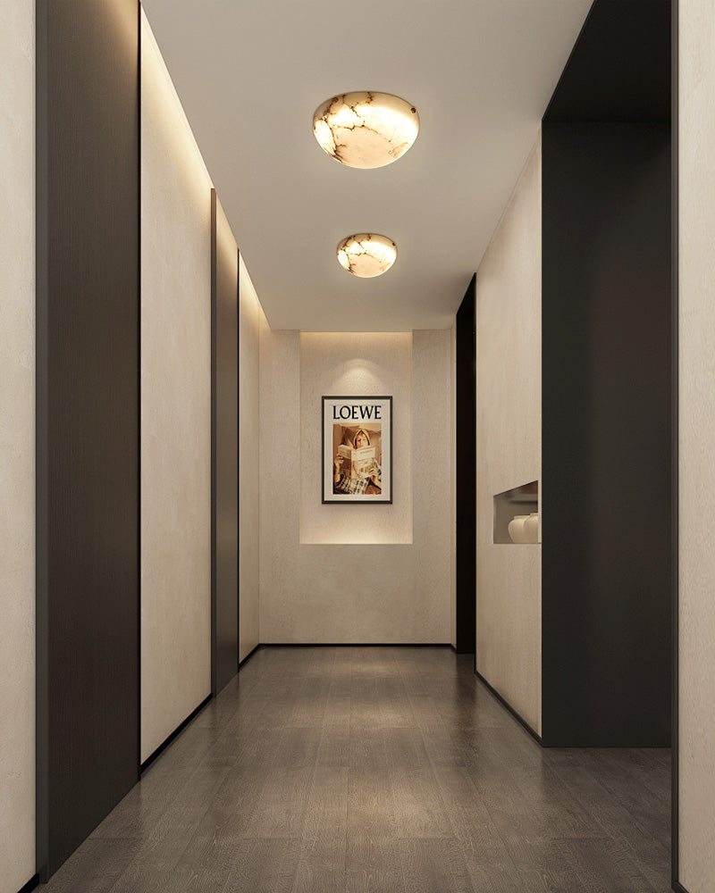 Modern hallway with LED alabaster ceiling lights and Loewe framed artwork