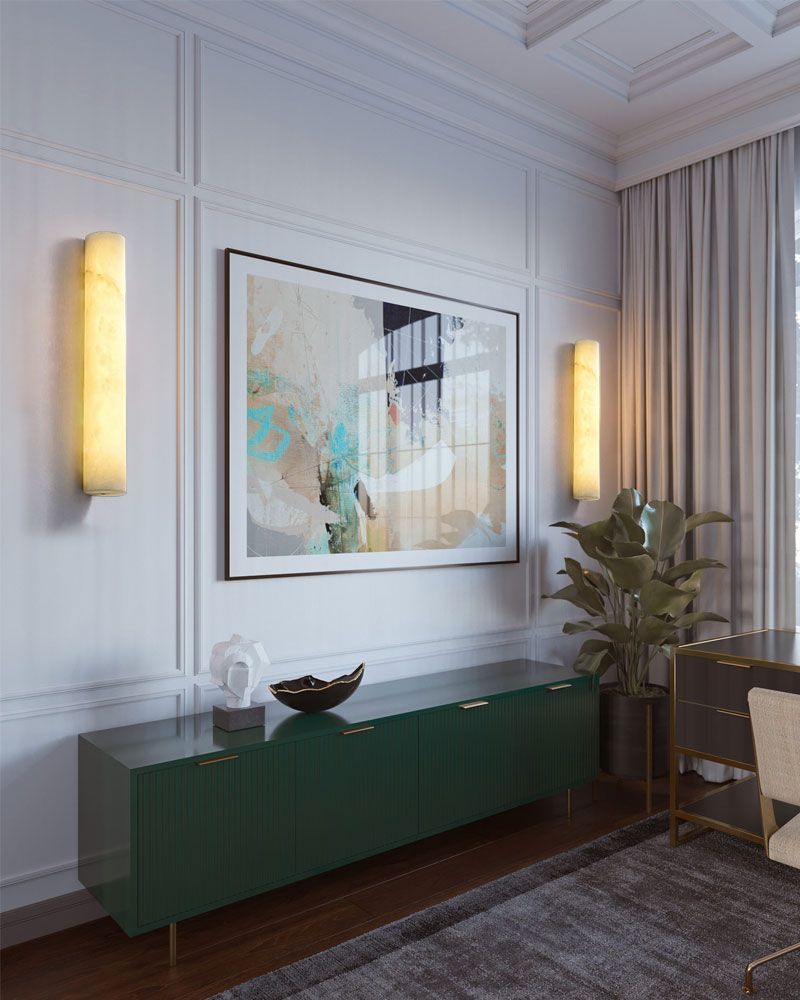 Modern living room with green console, wall art, and alabaster wall sconces