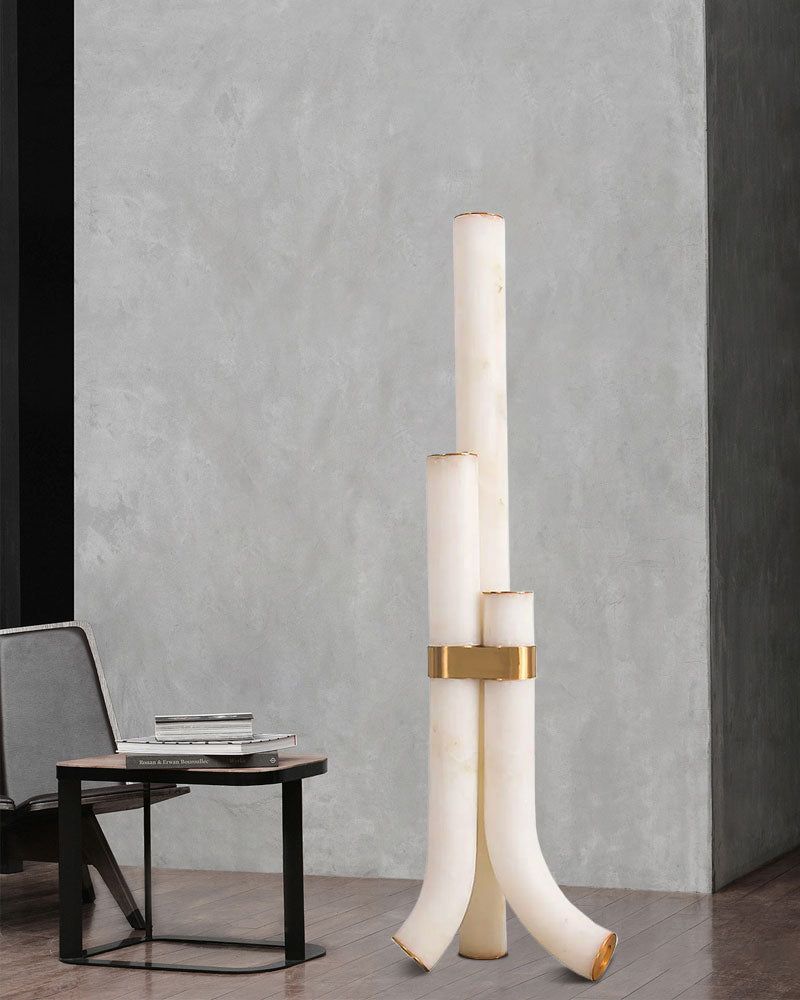 Modern white alabaster floor lamp with brass accents in a stylish interior
