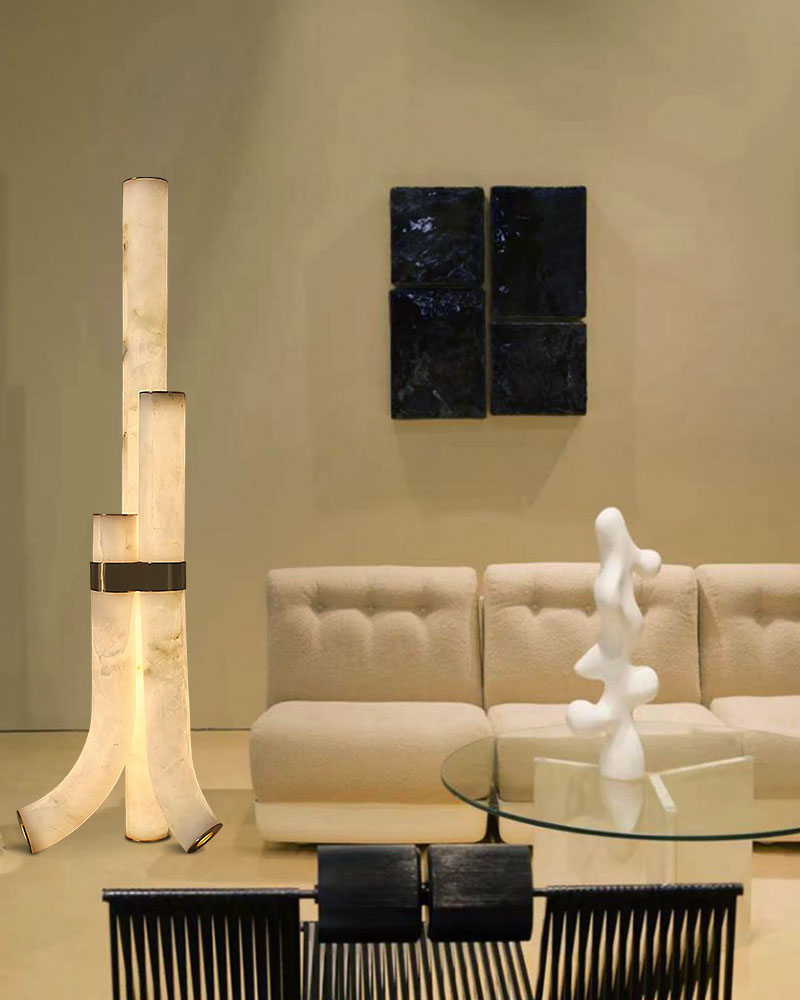 Piped alabaster floor lamp with warm glow beside modern beige sofa and glass table