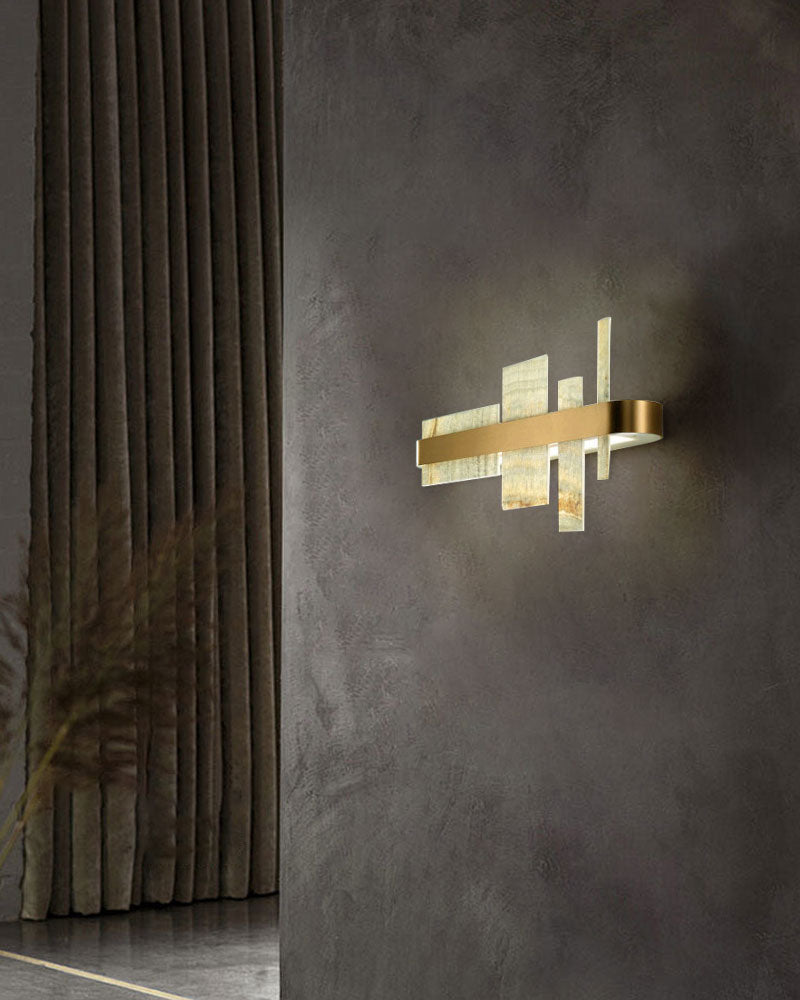 Sleek marble and metal wall sconce illuminating a modern textured wall