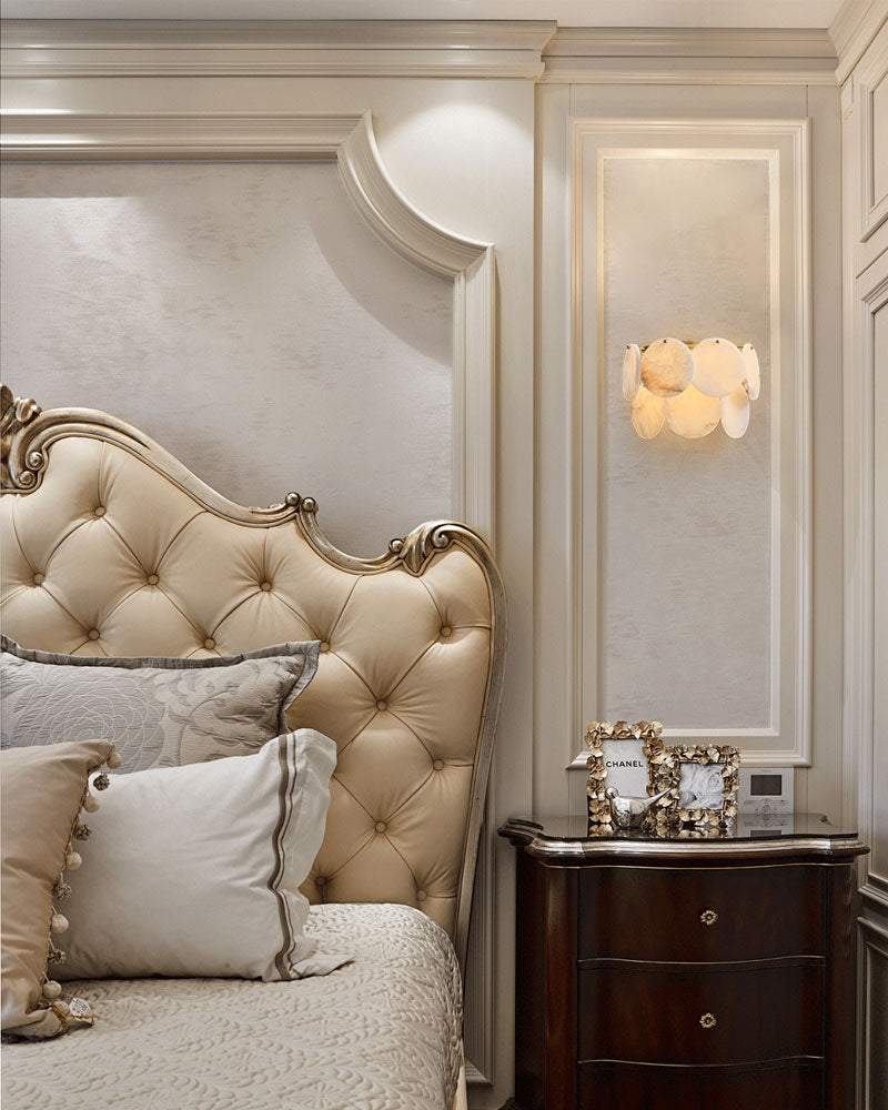 Spanish Alabaster Shell wall sconce in brass illuminating a sophisticated bedroom corner