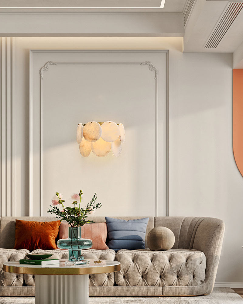 Spanish Alabaster Shell wall sconce in brass lighting a chic living room with sofa and decor