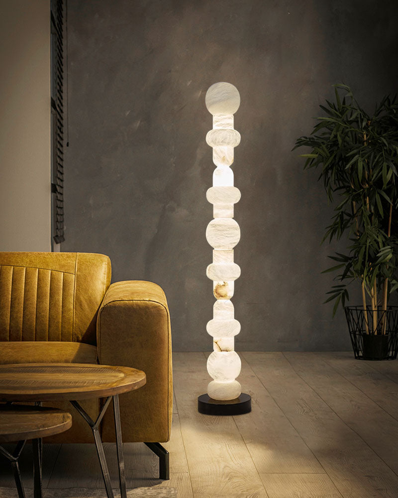 Stylish alabaster floor lamp with geometric design illuminating modern living room