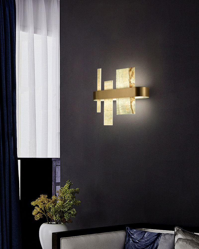 Stylish marble and metal wall sconce casting soft light in a modern living space