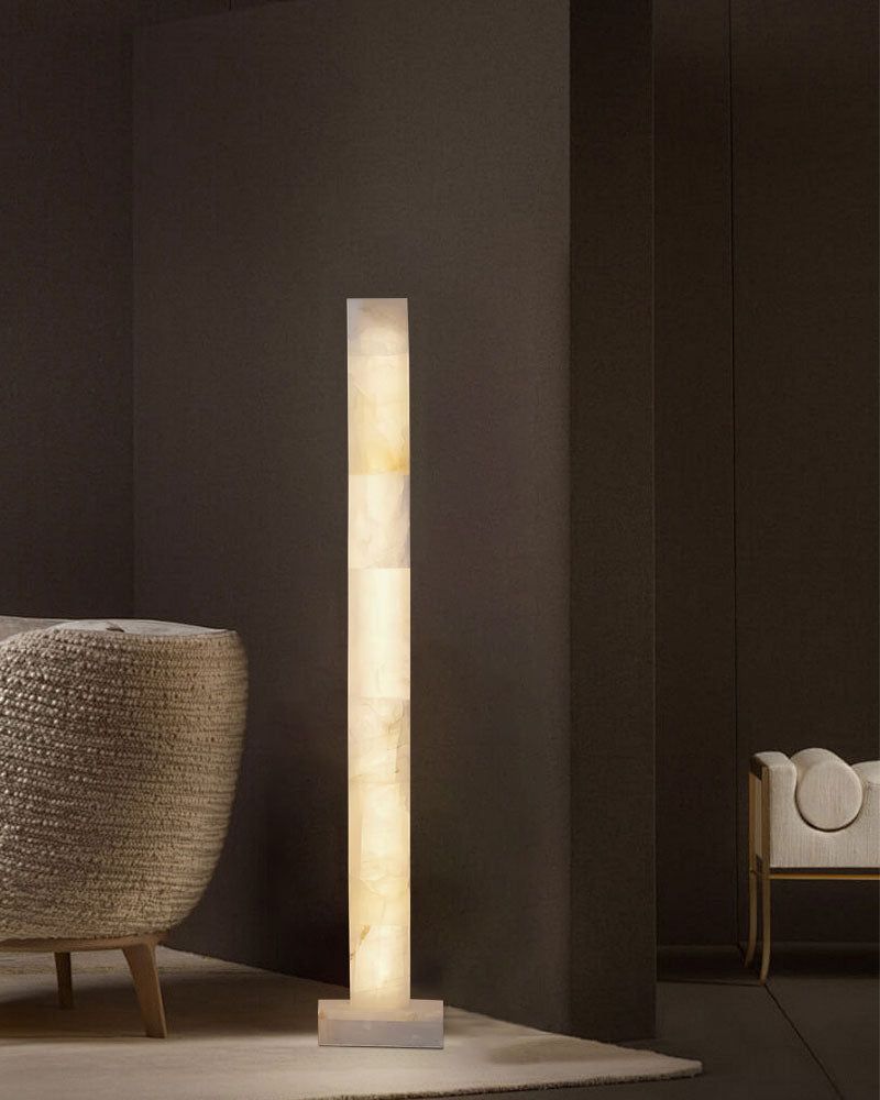 Tall alabaster floor lamp casting soft light in a stylish modern room