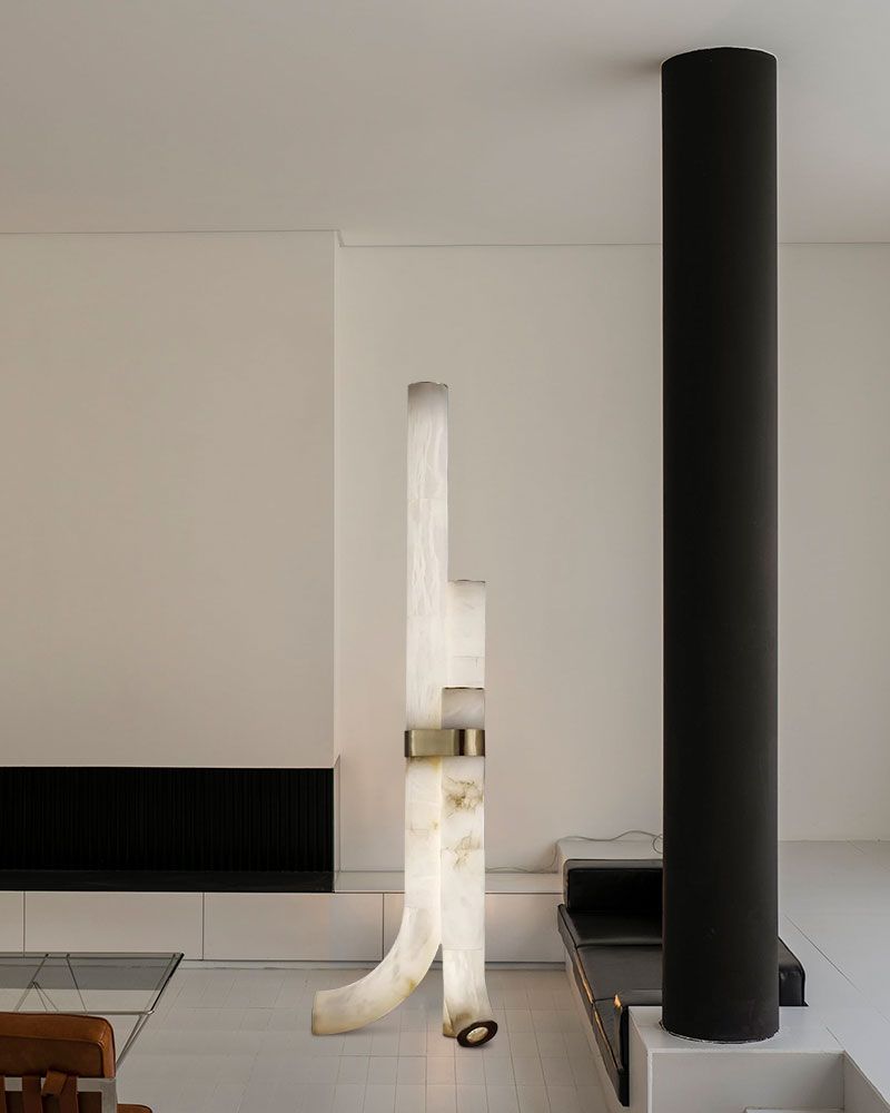 Unique white alabaster floor lamp with geometric shape and brass detail in modern interior