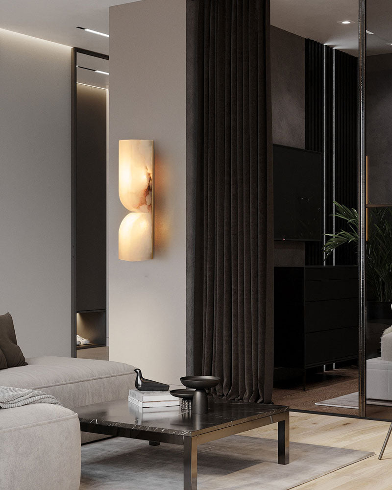 Stylish gray sofa with alabaster wall sconce in a modern living room